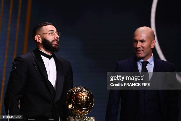 Real Madrid's French forward Karim Benzema receives the Ballon d'Or award from French former forward football player Zinedine Zidane during the 2022...