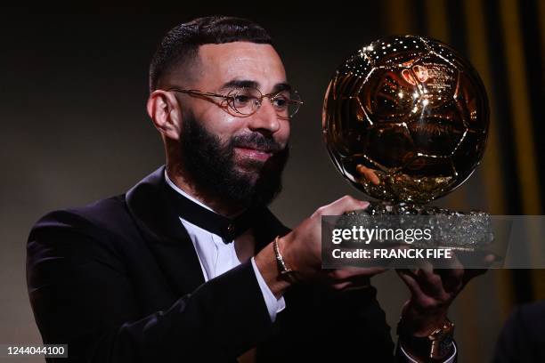 Real Madrid's French forward Karim Benzema receives the Ballon d'Or award during the 2022 Ballon d'Or France Football award ceremony at the Theatre...