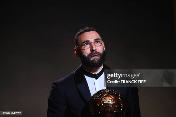 Real Madrid's French forward Karim Benzema receives the Ballon d'Or award during the 2022 Ballon d'Or France Football award ceremony at the Theatre...