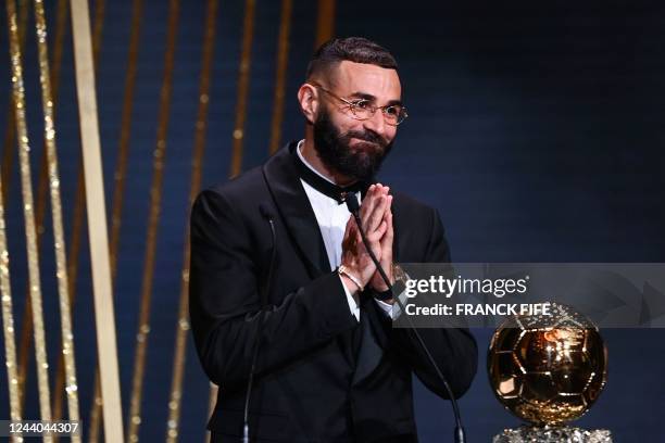 Real Madrid's French forward Karim Benzema receives the Ballon d'Or award during the 2022 Ballon d'Or France Football award ceremony at the Theatre...