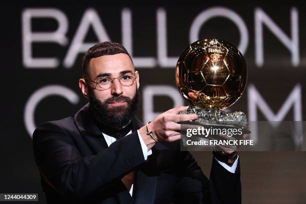 Real Madrid's French forward Karim Benzema receives the Ballon d'Or award during the 2022 Ballon d'Or France Football award ceremony at the Theatre...