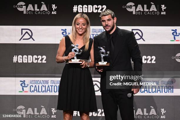 Juventus Italian midfielder Martina Rosucci and AC Milan's French defender Theo Hernandez react after respectively receiving on October 17, 2022 the...