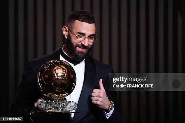 Real Madrid's French forward Karim Benzema receives the Ballon d'Or award during the 2022 Ballon d'Or France Football award ceremony at the Theatre...