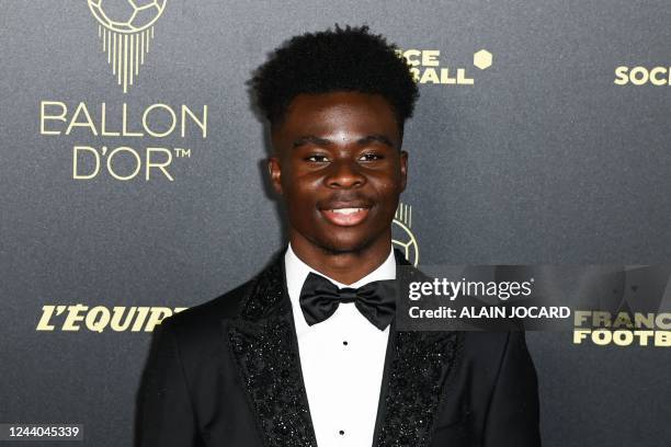 Arsenal's English midfielder Bukayo Saka poses upon arrival to attend the 2022 Ballon d'Or France Football award ceremony at the Theatre du Chatelet...