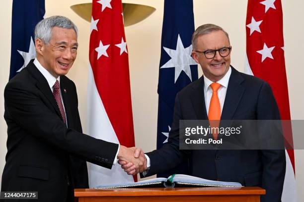 Prime Minister of Singapore Lee Hsien Loong shakes hands with Australian Prime Minister Anthony Albanese during a meeting at Parliament House on...