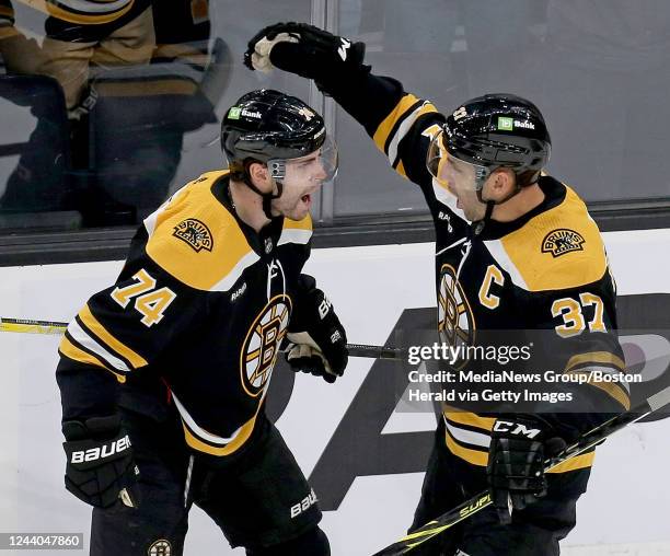 October 17: Jake DeBrusk of the Boston Bruins celebrates his goal with Patrice Bergeron of the Boston Bruins during the first period of the NHL game...