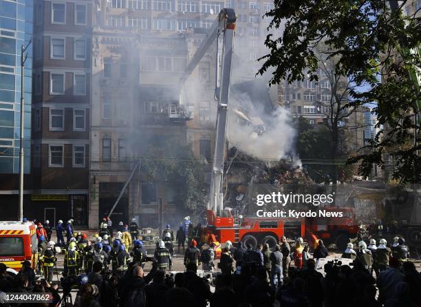 Firefighters work to put out a fire in a building destroyed by a Russian drone attack in Kyiv on Oct. 17, 2022.