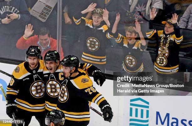 October 17: Young fans cheer as Patrice Bergeron of the Boston Bruins screams out after scoring with Pavel Zacha and Connor Clifton during the second...