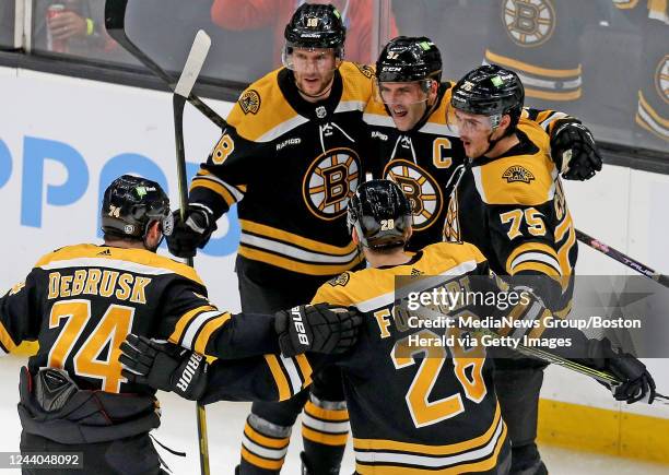 October 17: Patrice Bergeron of the Boston Bruins screams out after scoring with Pavel Zacha, Connor Clifton, Jake DeBrusk and Derek Forbort during...