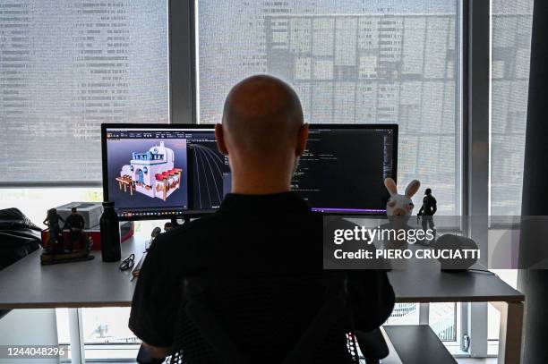 An employee works on a pen display at the "Mario + The Lapins Crétins: Sparks of Hope" game at the Ubisoft headquarter in Milan on October 7, 2022. -...