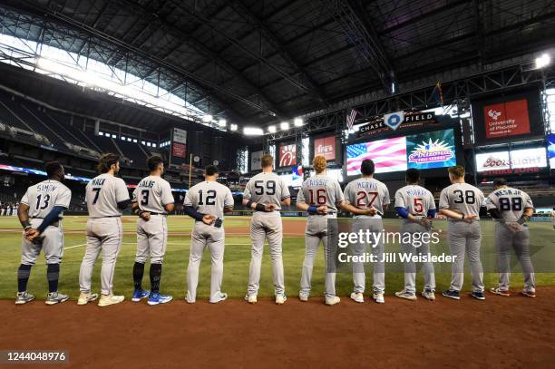 Members of the Mesa Solar Sox stand on the field for the national anthem before the game between the Mesa Solar Sox and the Glendale Desert Dogs at...