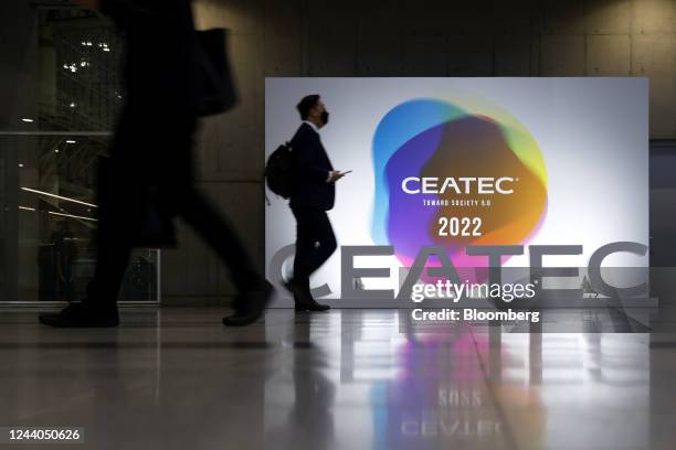 Attendees walk past signage at the Combined Exhibition of Advanced Technologies in Chiba, Japan, on Tuesday, Oct. 18, 2022. CEATEC, the annual...