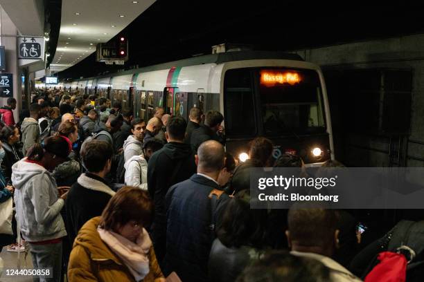 Passengers wait to board a congested train during a national strike at Gare du Nord train station in Paris, France, on Tuesday, Oct. 18, 2022. French...