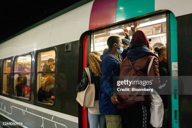 Passengers board a congested train during a national strike at Gare du Nord train station in Paris, France, on Tuesday, Oct. 18, 2022. French rail,...