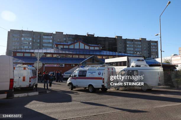 Emergencies cars are seen parked in front of a partially destroyed nine-storey apartment building after a Sukhoi Su-34 military jet crashed in the...