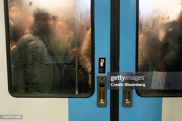 Passengers travel in a congested train during a national strike at Gare du Nord train station in Paris, France, on Tuesday, Oct. 18, 2022. French...