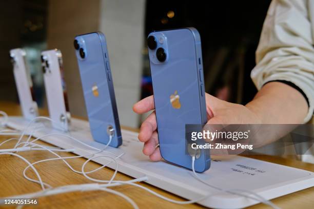 Customer is picking up a sample iPhone 14 in an Apple store. On October 7, the iPhone 14 series were launched in the Chinese Mainland market....