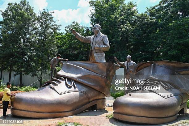 Labourers work on the shoes of a 125-feet tall statue of social reformer Dr. B.R. Ambedkar in Hyderabad on October 18, 2022.