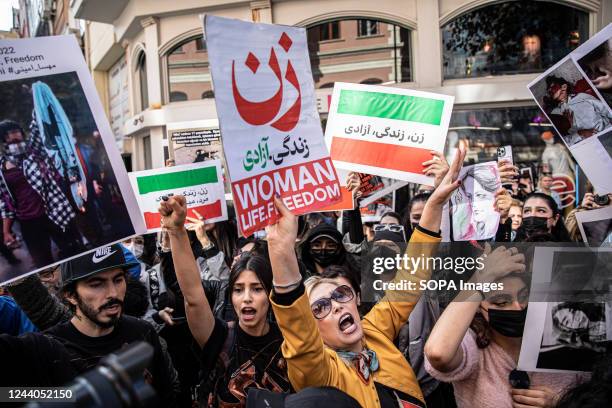Protesters hold placards and chant slogans outside the Iranian Consulate in Istanbul during a protest over the death of Iranian Mahsa Amini....