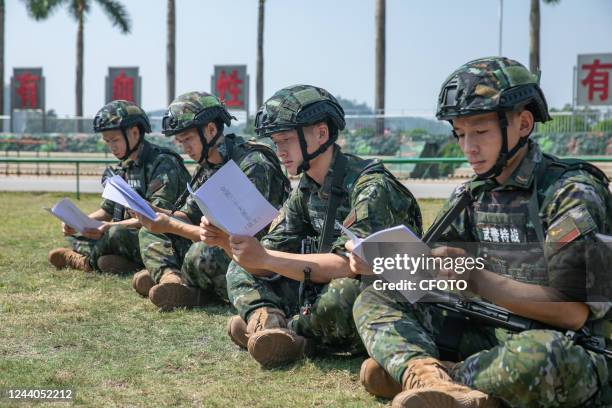 Armed police officers learn the contents of the report to the 20th Congress of the Communist Party of China at a training ground in Nanning, South...