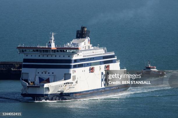 Ship BF Hurricane goes past a P&O ferry as it arrives in Dover carrying migrants picked up in the English Channel on October 18, 2022. Accusing...