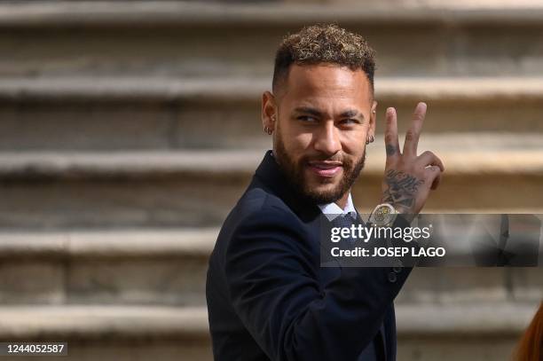 Paris Saint-Germain's Brazilian forward Neymar gestures as he leaves after attending a hearing at the courthouse in Barcelona on October 18 on the...
