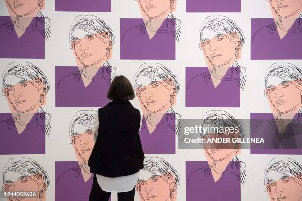 Visitor looks at the artwork "Facsimile of Self-Portrait wallpaper" by US artist Andy Warhol during the presentation of the "25 Years of the Museum...