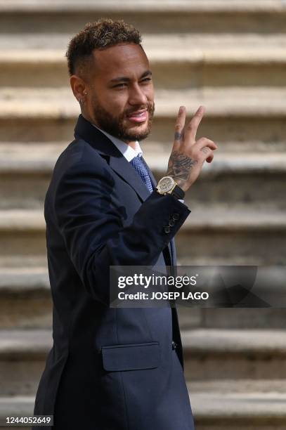 Paris Saint-Germain's Brazilian forward Neymar gestures as he leaves after attending a hearing at the courthouse in Barcelona on October 18 on the...
