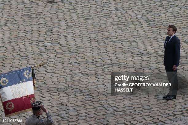 French President Emmanuel Macron stands during the tribute to veterans of the Algerian war, at the Invalides in Paris, on October 18 as part of the...