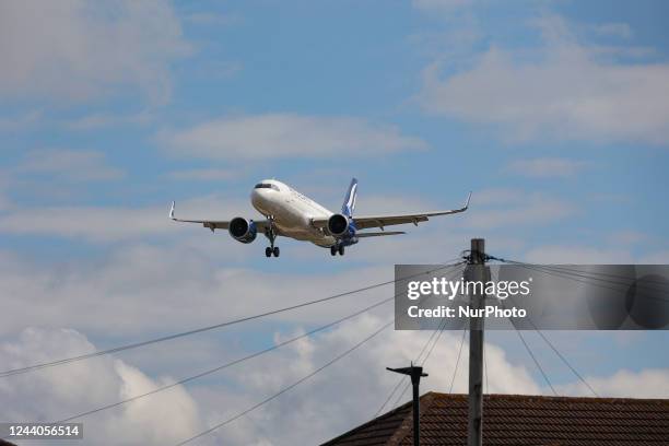 Aegean Airlines Airbus A320NEO aircraft as seen on final approach flying over the houses of Myrtle avenue in London, a famous location for plane...