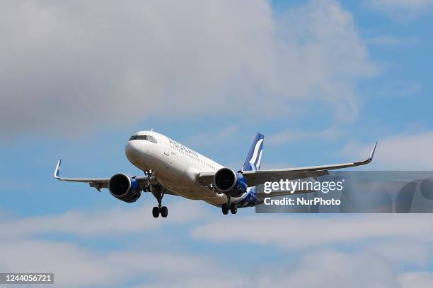 Aegean Airlines Airbus A320NEO aircraft as seen on final approach flying over the houses of Myrtle avenue in London, a famous location for plane...