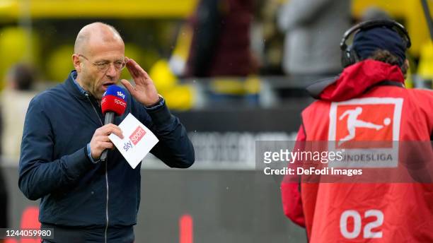 Patrick Wasserziehr with a moderation sheet of Sky Sports and the Bundeliga logo prior to the Bundesliga match between Borussia Dortmund and FC...