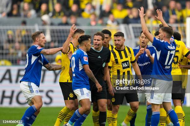 Referee Felix Brych discussing in the middle of the players during the Bundesliga match between Borussia Dortmund and FC Schalke 04 at Signal Iduna...