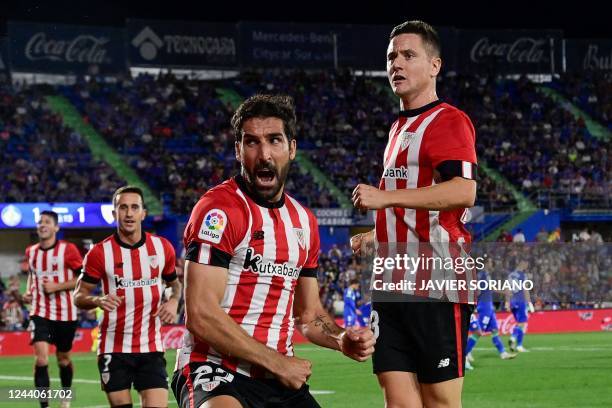 Athletic Bilbao's Spanish midfielder Raul Garcia celebrates with teammates after scoring his team's second goal during the Spanish League football...