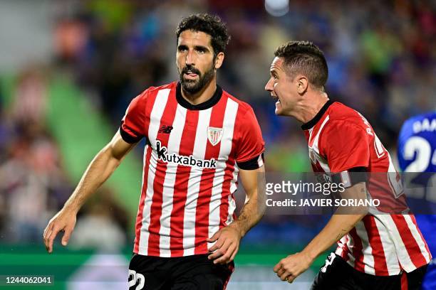 Athletic Bilbao's Spanish midfielder Raul Garcia celebrates with teammates after scoring his team's second goal during the Spanish League football...