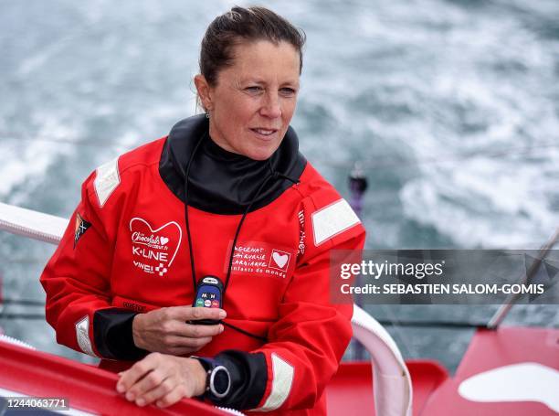 British skipper Samantha Davies poses as she sails aboard her Imoca monohull « Initiatives Coeur » off Lorient, western France, on October 18 in...