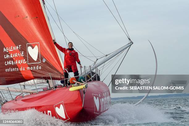 British skipper Samantha Davies poses as she sails aboard her Imoca monohull « Initiatives Coeur » off Lorient, western France, on October 18 in...