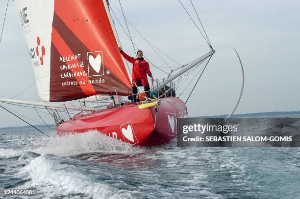 British skipper Samantha Davies poses as she sails aboard her Imoca monohull « Initiatives Coeur » off Lorient, western France, on October 18 in...