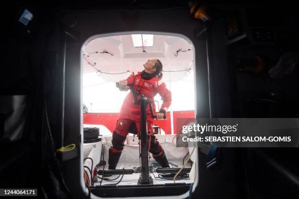 British skipper Samantha Davies poses as she sails aboard her Imoca monohull « Initiatives Coeur » off Lorient, western France, on October 18 in...