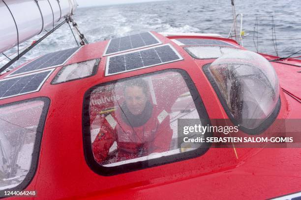 British skipper Samantha Davies poses as she sails aboard her Imoca monohull « Initiatives Coeur » off Lorient, western France, on October 18 in...