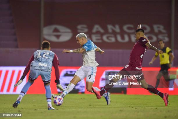 Enzo Copetti of Racing Club kicks the ball to score the first goal of his team during a match between Lanus and Racing Club as part of Liga...