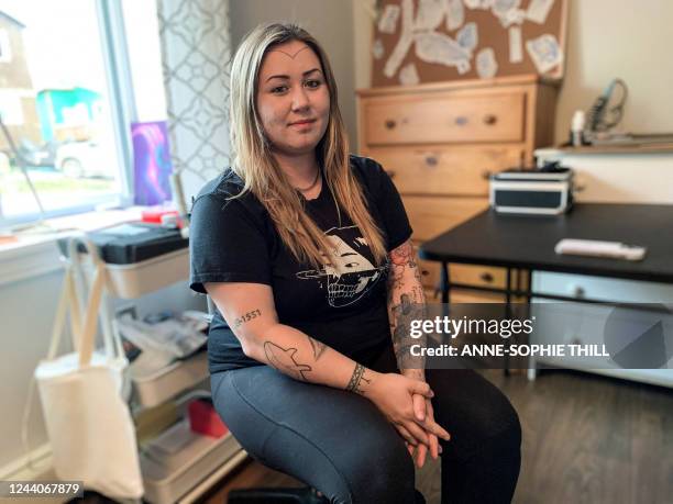 Inuit tattoo artist Kyra Kilabuk poses for a photo on July 28, 2022 in Iqaluit, Nunavut, Canada. V-shapes on temples, dots on cheeks and lines on...