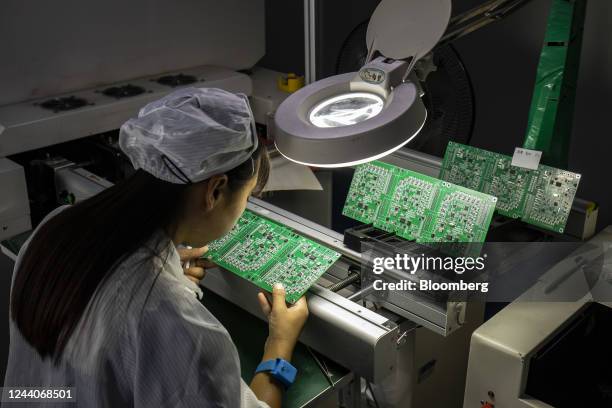 An employee inspect integrated circuit boards at the Smart Pioneer Electronics Co. Factory in Suzhou, China, on Friday, Sept. 23, 2022. In a world...