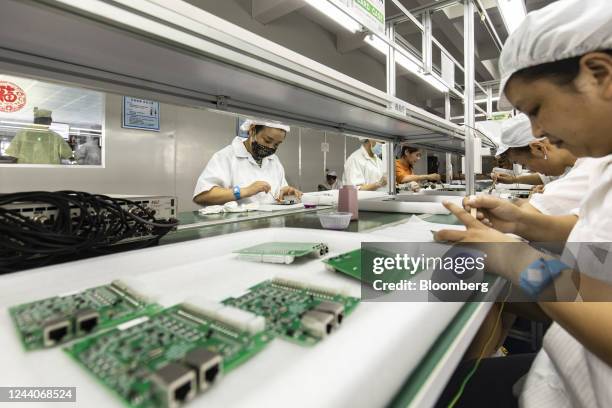 Employees on the integrated circuit board production line at the Smart Pioneer Electronics Co. Factory in Suzhou, China, on Friday, Sept. 23, 2022....