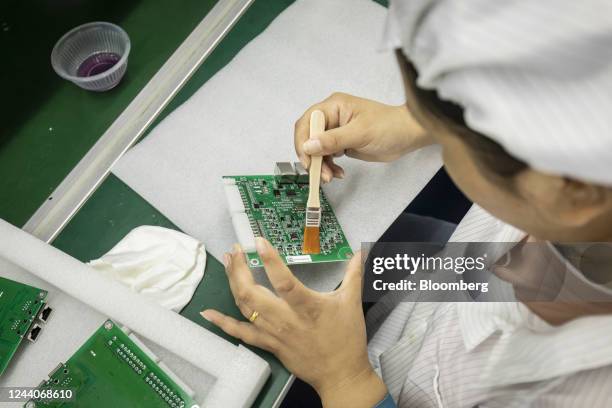 Employees on the integrated circuit board production line at the Smart Pioneer Electronics Co. Factory in Suzhou, China, on Friday, Sept. 23, 2022....