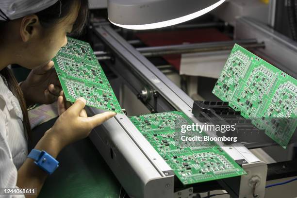 An employee inspects integrated circuit boards at the Smart Pioneer Electronics Co. Factory in Suzhou, China, on Friday, Sept. 23, 2022. In a world...