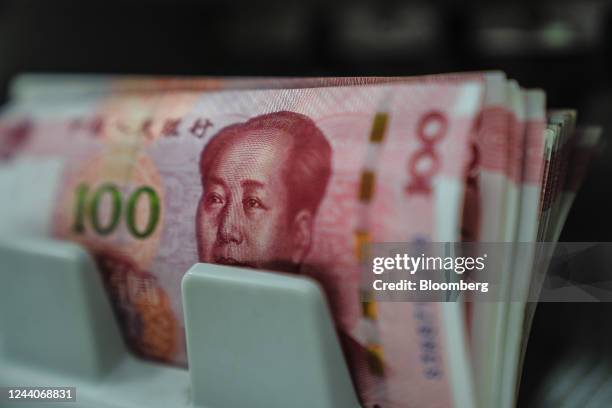 Chinese one-hundred yuan banknotes going through a currency counting machine arranged in Hong Kong, China, on Tuesday, Oct. 18, 2022. China's central...