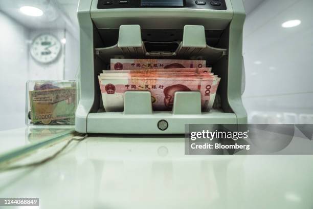 Chinese one-hundred yuan banknotes going through a currency counting machine arranged in Hong Kong, China, on Tuesday, Oct. 18, 2022. China's central...