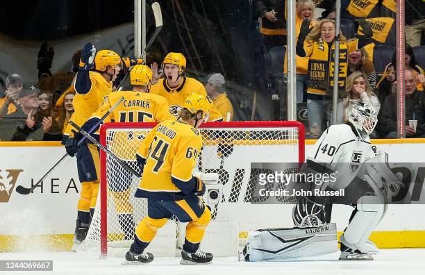Cody Glass celebrates his goal with Alexandre Carrier and Jeremy Lauzon of the Nashville Predators against Cal Petersen of the Los Angeles Kings...