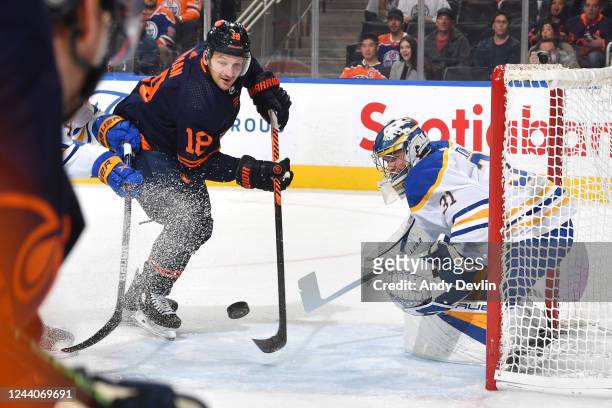 Zach Hyman of the Edmonton Oilers takes a shot on Eric Comrie of the Buffalo Sabres on October 18, 2022 at Rogers Place in Edmonton, Alberta, Canada.